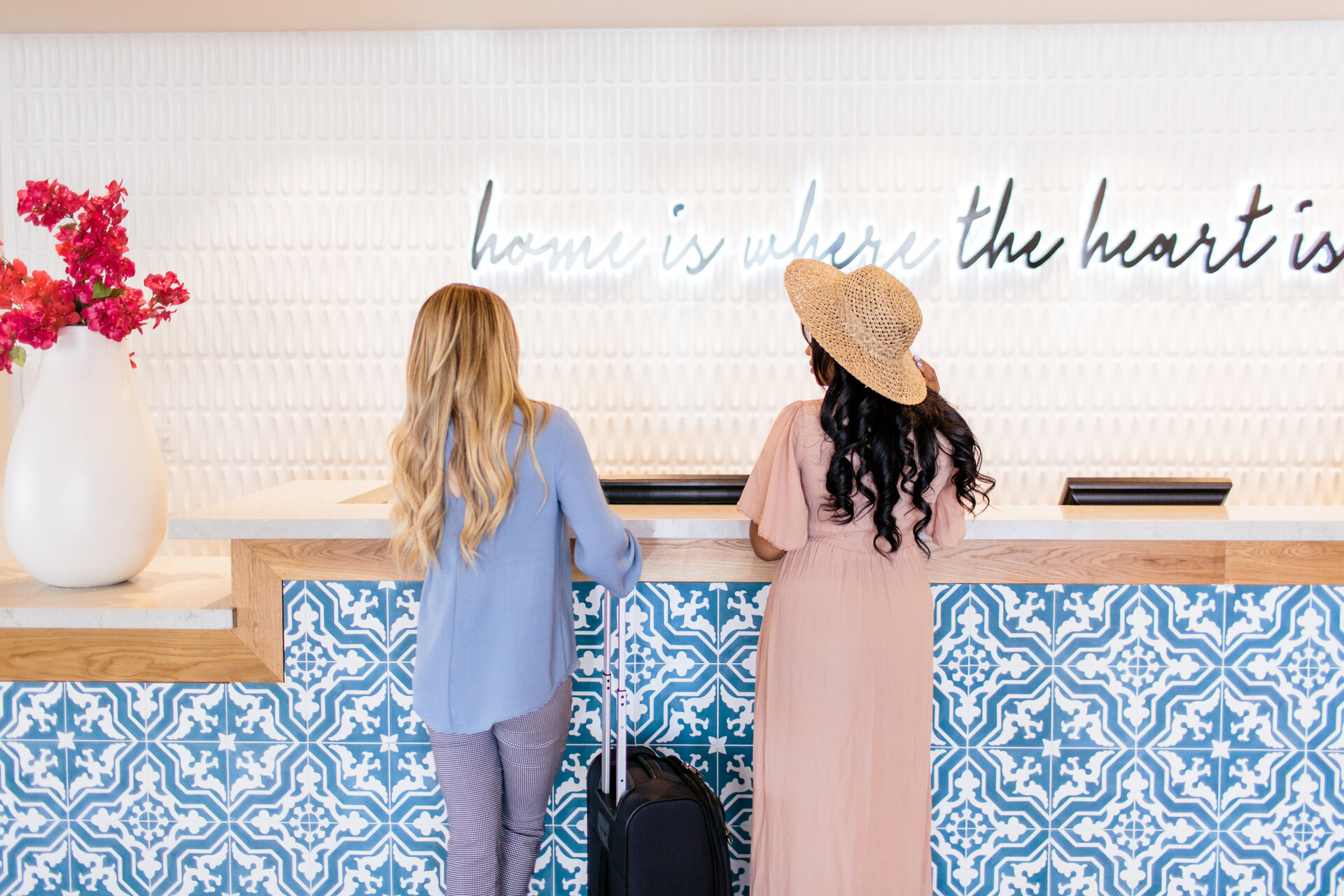 two women standing at front desk