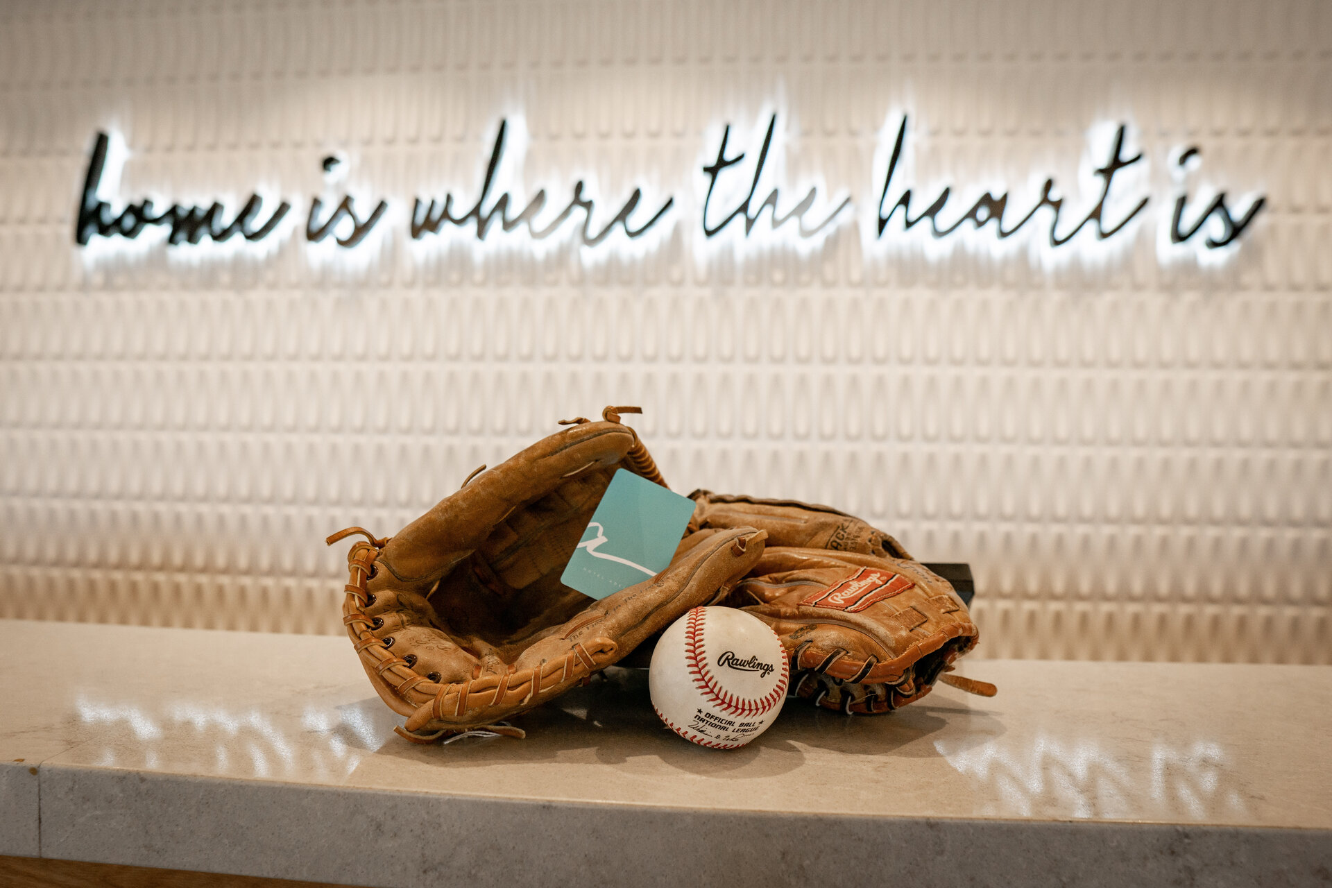 baseball gloves and ball on front desk